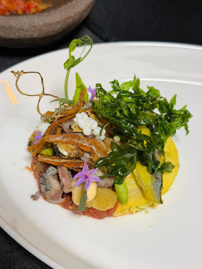 Artistic presentation of Indonesian cuisine with intricate garnishing, highlighting regional flavors.
